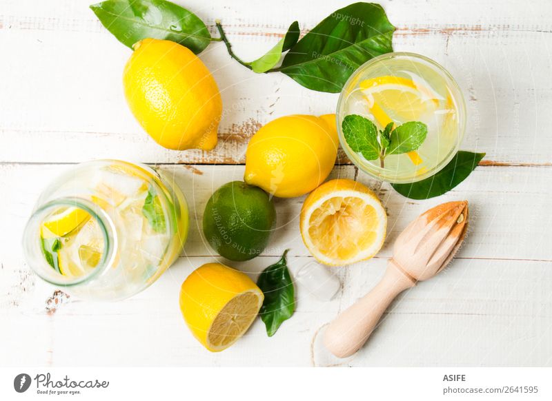 Homemade lemonade with reamer on white wooden table Fruit Diet Beverage Lemonade Juice Summer Table Leaf Wood Cool (slang) Fresh Above Yellow Green White lime