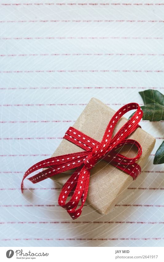 Gift box, wrapped in recycled paper and red bow Roll Shopping Elegant Valentine's Day Mother's Day Easter Thanksgiving Christmas & Advent New Year's Eve