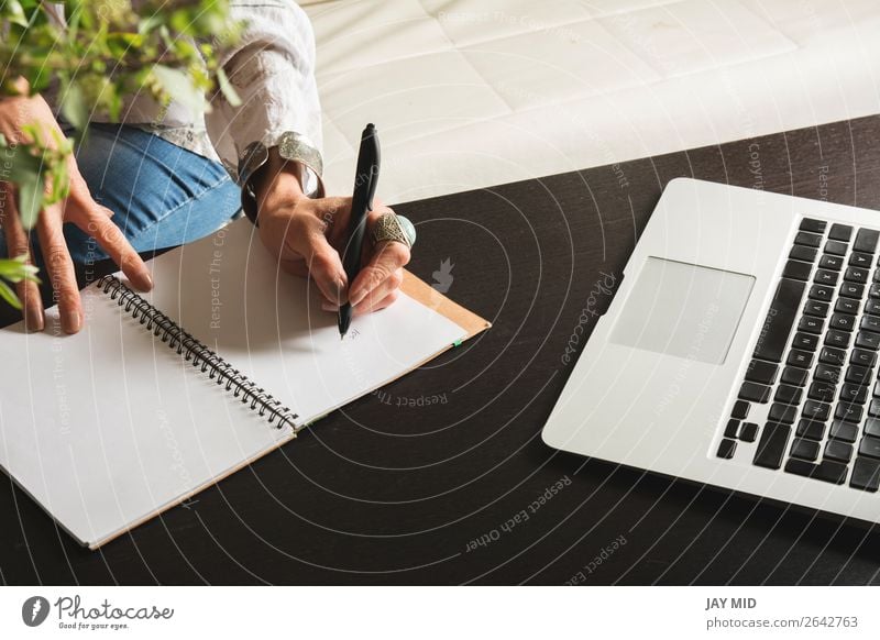 Woman hands writes a pen in a notebook, computer keyboard Lifestyle Work and employment Office Business Computer Technology Human being Adults Hand Paper Pen