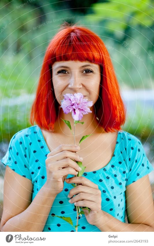 Redhead woman smelling a flower in a park Lifestyle Happy Beautiful Face Wellness Relaxation Fragrance Summer Garden Human being Woman Adults Nature Tree Flower