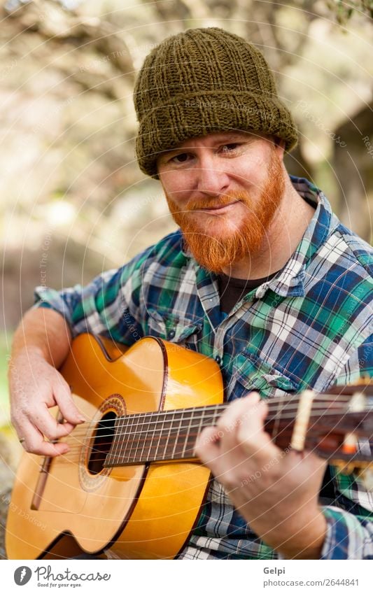 Hipster man with red beard playing a guitar Leisure and hobbies Playing Entertainment Music Human being Man Adults Musician Guitar Nature Red-haired Moustache