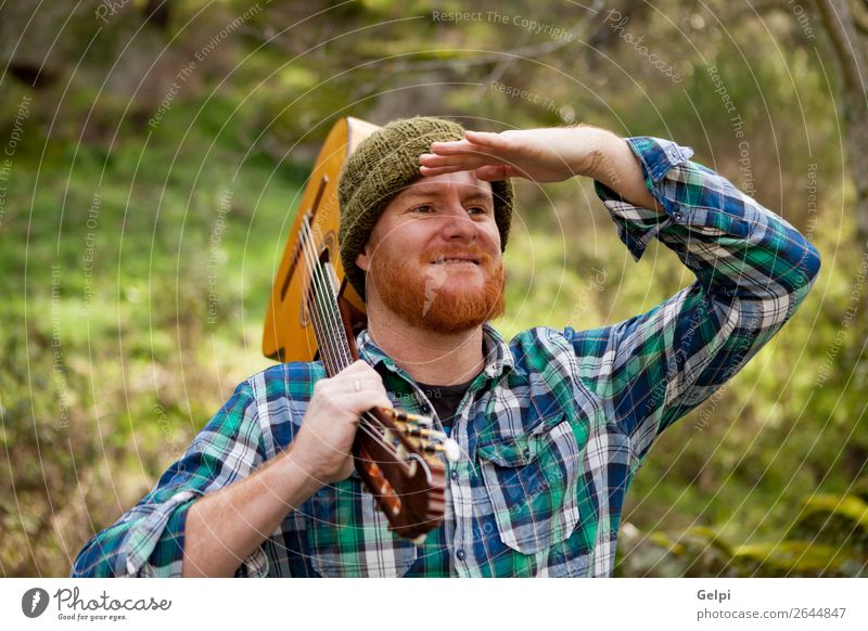 Hipster man holding a guitar and looking Leisure and hobbies Playing House (Residential Structure) Entertainment Music Human being Man Adults Musician Guitar