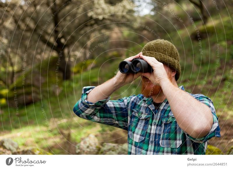 Young Man using binoculars Lifestyle Beautiful Vacation & Travel Adventure Freedom Summer Hiking Human being Adults Nature Landscape Autumn Tree Forest Shirt