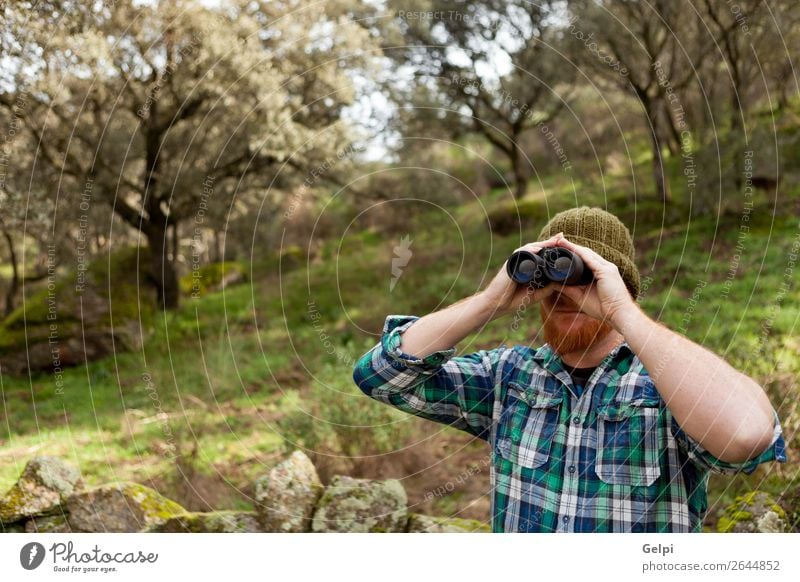 Young Man using binoculars Lifestyle Beautiful Vacation & Travel Adventure Freedom Summer Hiking Human being Adults Nature Landscape Autumn Tree Forest Shirt