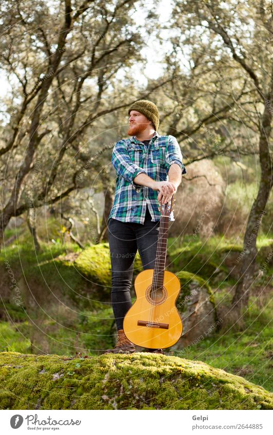 Hipster man with red beard and a guitar relaxs Leisure and hobbies Playing Entertainment Music Human being Man Adults Musician Guitar Nature Red-haired