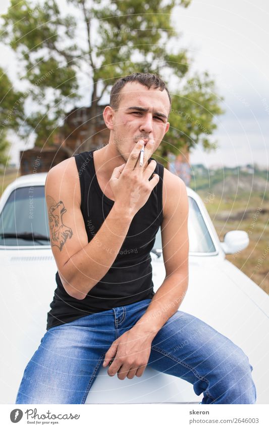 brutal guy with a tattoo smokes a cigarette Parenting Education Work and employment Profession Masculine Young man Youth (Young adults) 1 Human being