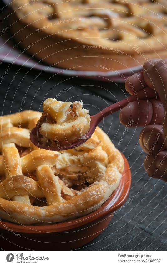 Spoon with apple pie held in hand. Dessert eating. Cake Candy Eating Breakfast Table Thanksgiving To enjoy Sweet Black Tradition November American Apple pie