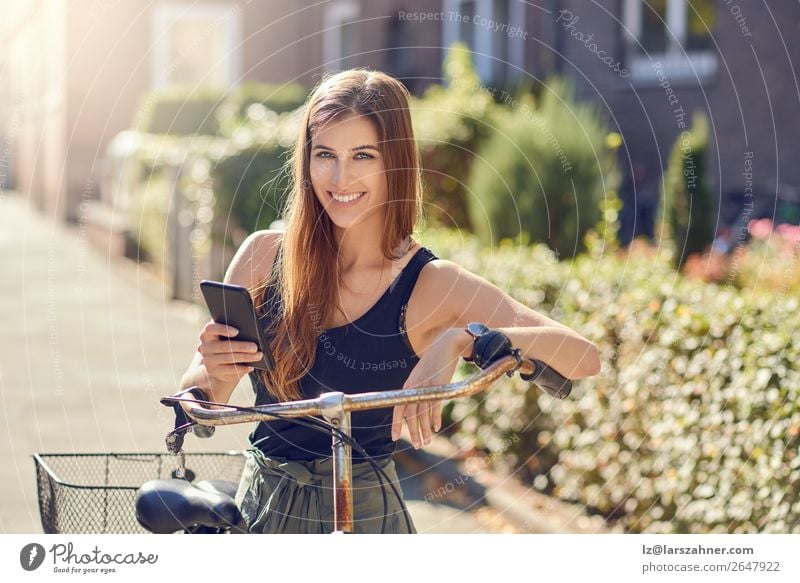 Beautiful woman with bicycle and smartphone Happy Face Summer Business PDA Technology Woman Adults 1 Human being 18 - 30 years Youth (Young adults) Warmth