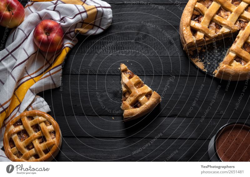 Apple pies and one slice in the middle. Top view. Sweet pastry Cake Dessert Candy Breakfast Hot Chocolate Winter Table Thanksgiving Christmas & Advent Black