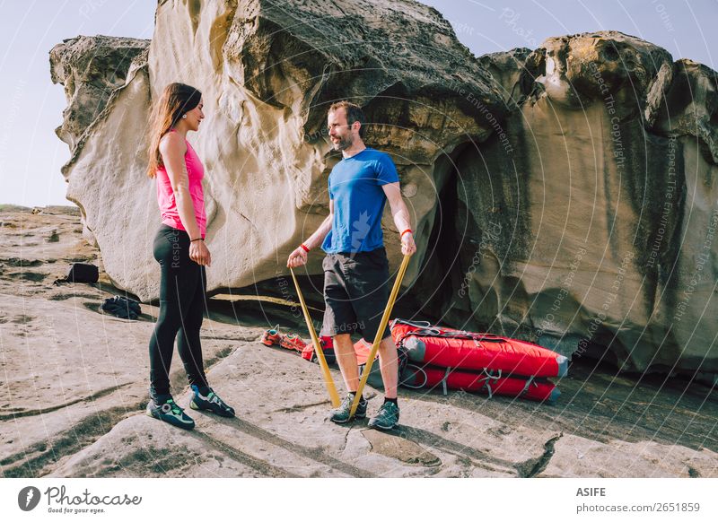 Couple of climbers warming up before climbing Joy Leisure and hobbies Adventure Ocean Mountain Hiking Sports Climbing Mountaineering Woman Adults Man Partner