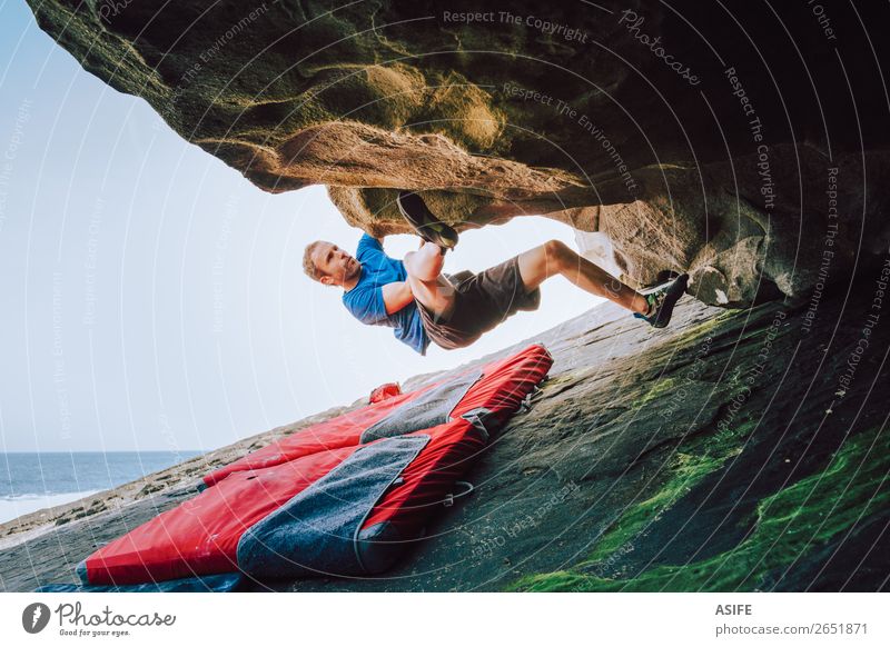 Young climber man climbing at the coast Joy Happy Leisure and hobbies Adventure Ocean Mountain Hiking Sports Climbing Mountaineering Man Adults Nature Rock