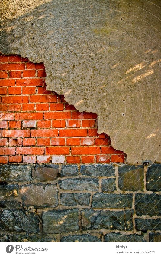 Fallen off plaster on brick wall. Weathered wall of brick, natural stone and dilapidated plaster. In need of renovation Wall (barrier) Wall (building) Plaster