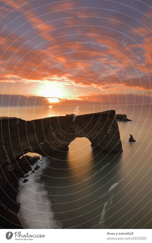 Cliff and arch of Dyrhólaey, Iceland Nature Landscape Elements Earth Air Water Cloudless sky Clouds Horizon Sunrise Sunset Climate Hill Rock Coast Beach