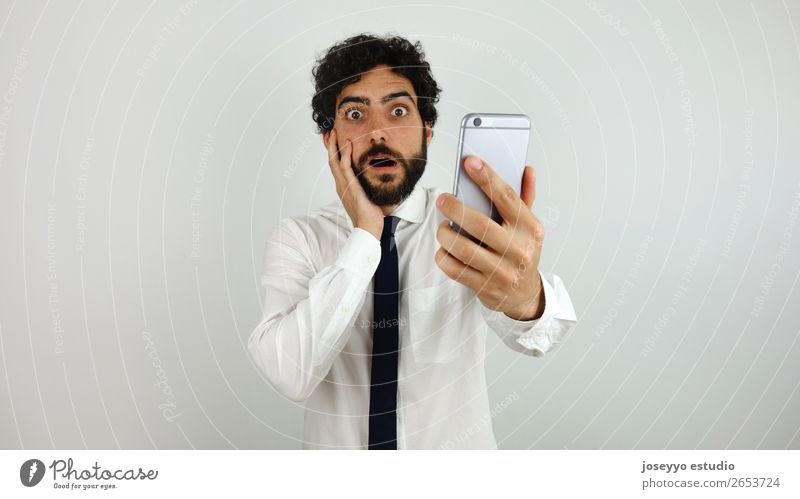 Business man with mobile phone in his hand Amazed Beard Businessman To call someone (telephone) Cellphone Communication Expression Face Hand Looking Man Office