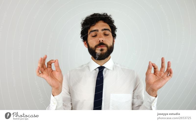 Young businessman doing relaxation exercise. Lifestyle Health care Harmonious Relaxation Calm Meditation Vacation & Travel Office Business Man Adults