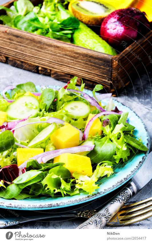 Vegetarian salad with vegetable and mango spring green lettuce vitamin leaf herb fresh food healthy diet vegetarian plate arugula natural cucumber fruit onion