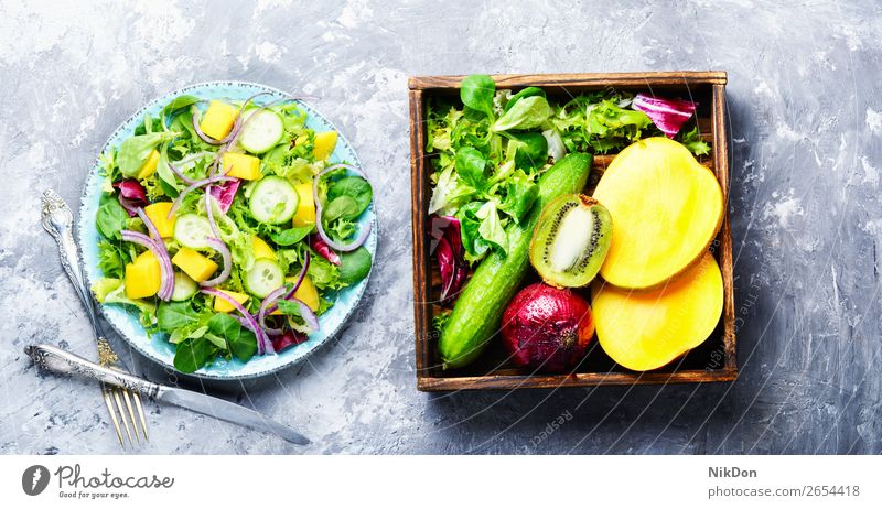 Vegetarian salad with vegetable and mango spring green lettuce vitamin leaf herb fresh food healthy diet vegetarian plate arugula natural cucumber fruit onion