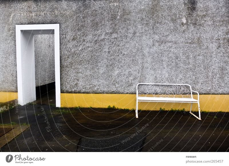 seating Manmade structures Building Architecture Wall (barrier) Wall (building) Facade Door Old Yellow Bench Wet Gloomy Loneliness Empty Entrance Asphalt Gray