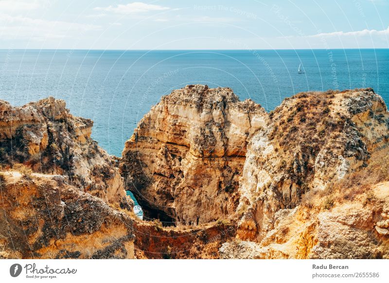 Ocean Landscape With Rocks And Cliffs At Lagos Bay Coast In Algarve, Portugal Nature Hole Cave Beach Stone Arch Window Vantage point Beautiful Vacation & Travel