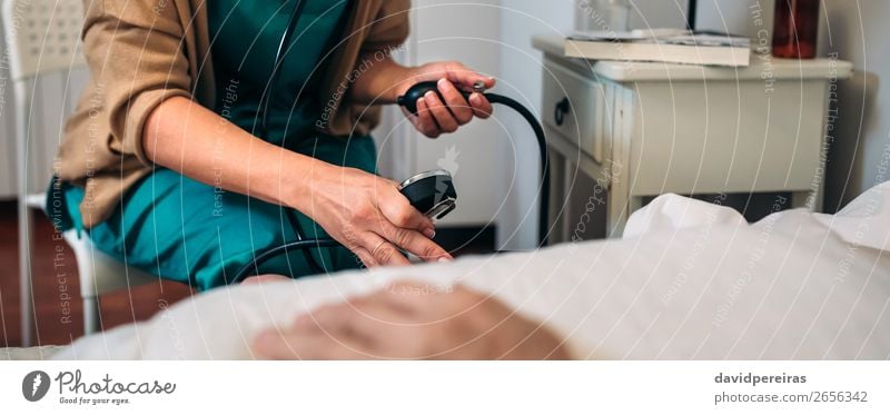 Caregiver checking blood pressure to a senior woman Health care Medication House (Residential Structure) Examinations and Tests Doctor Hospital Internet