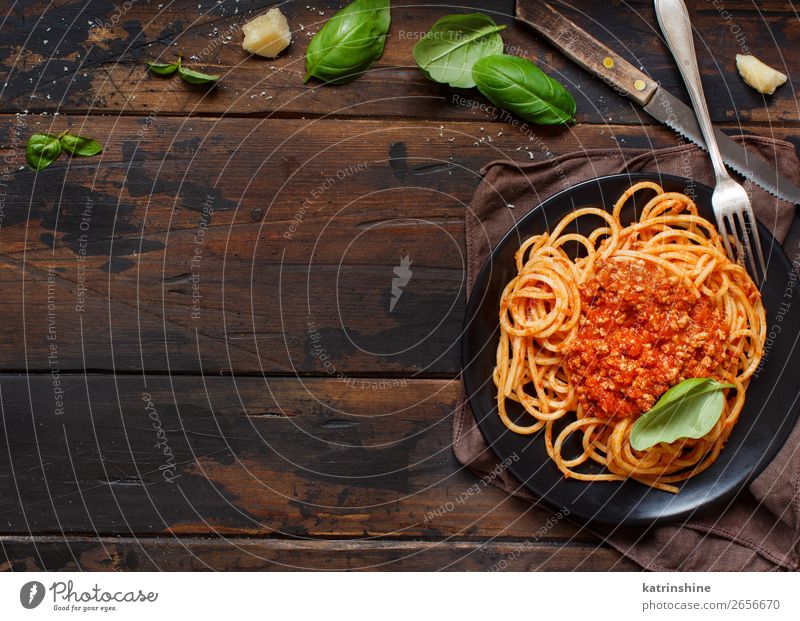 Spaghetti pasta with bolognese sauce Meat Cheese Herbs and spices Lunch Dinner Plate Fork Wood Bright Above Tradition Basil Beef Bolognese Cooking Dish food