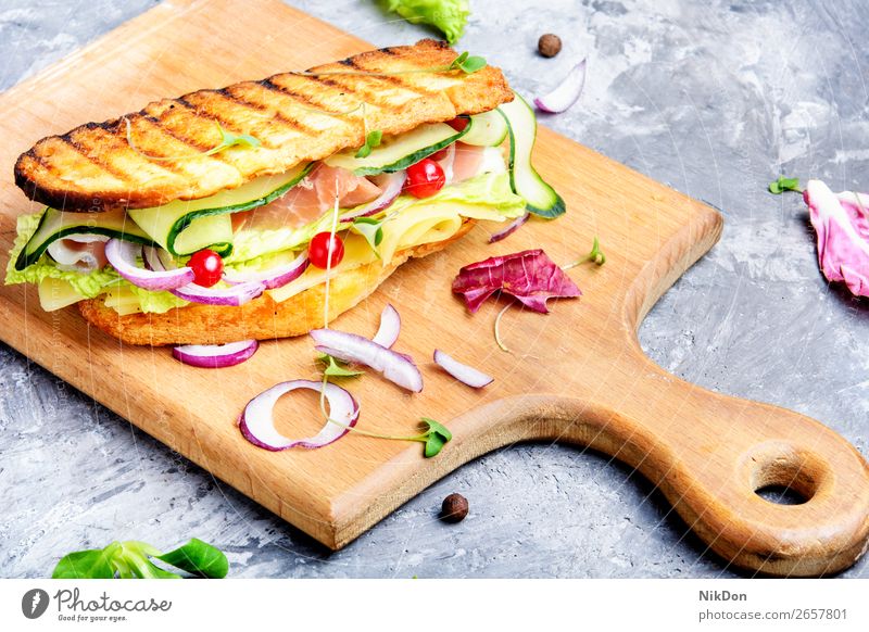 Sandwiches on cutting board food bread sandwich lettuce snack dinner vegetable breakfast meat salad healthy ham green toast toasted cucumber bacon bun closeup