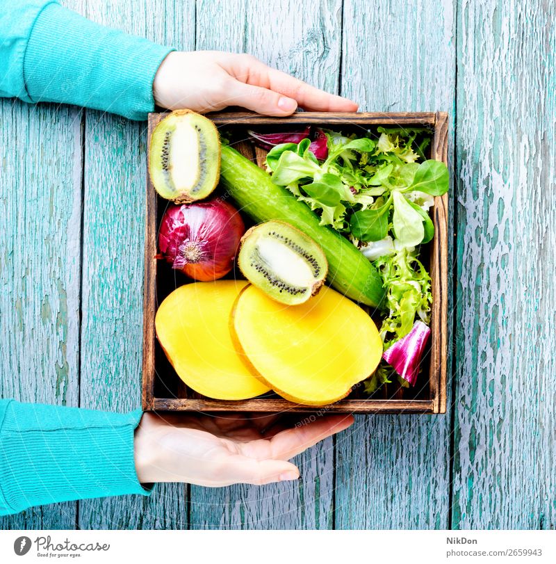 Assortment of fresh fruits and vegetables food hand healthy diet green vegetarian cucumber harvest mango natural vitamin ripe eating raw market vegan detox