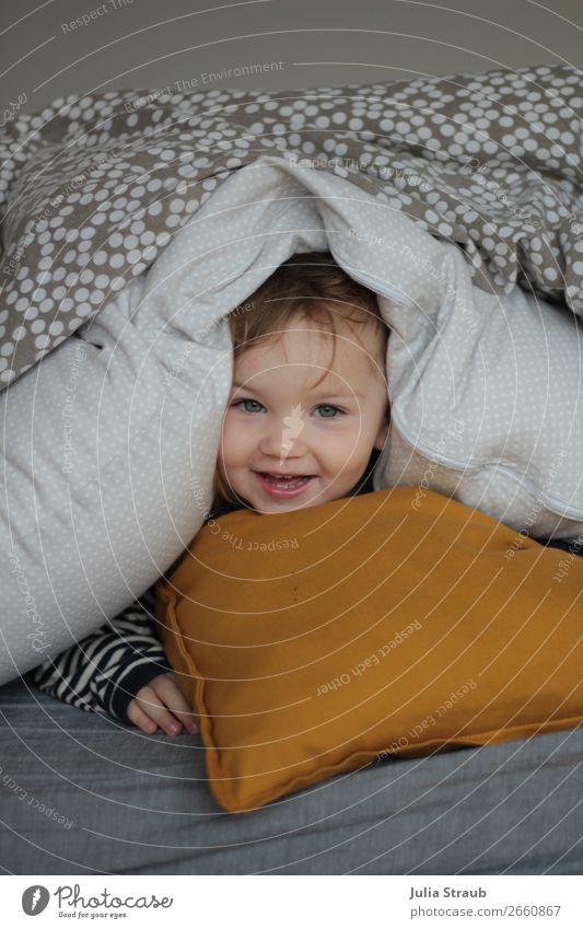 Girl playing hide and seek in bed House (Residential Structure) Bed Bedroom Feminine Toddler Head 1 Human being Brunette Blonde Bangs Laughter Lie Looking