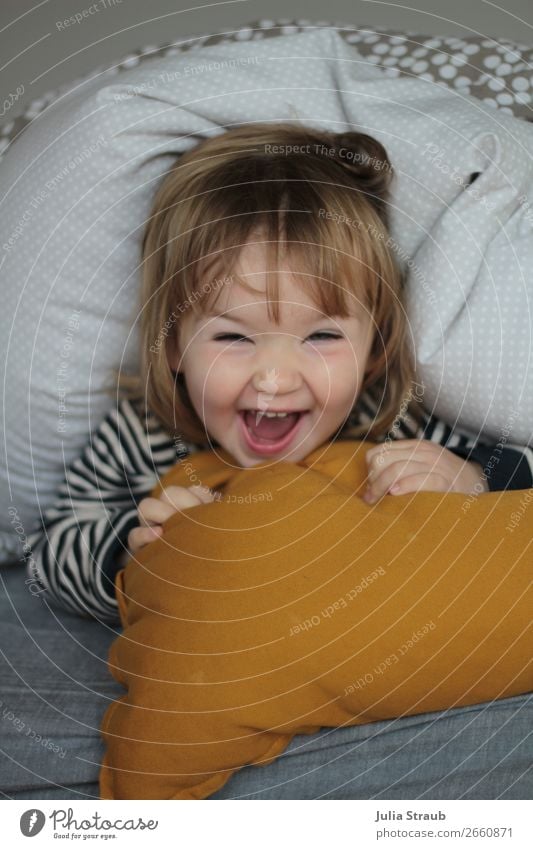 Bed Blanket Hide Toddler Fun Feminine Girl 1 Human being 1 - 3 years T-shirt Striped Brunette Blonde Bangs Laughter Scream Romp Happiness Funny Yellow Gray