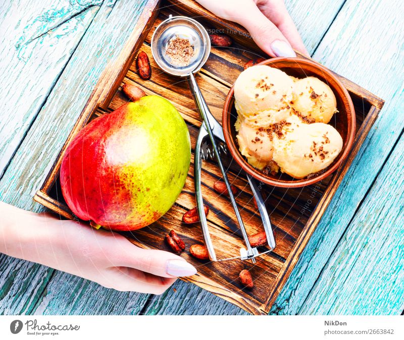 Ice cream with mango flavor ice-cream dessert tray scoop vanilla sundae summer icecream hand frozen ball milk fruit spoon bowl creamy seasonal sorbet colorful