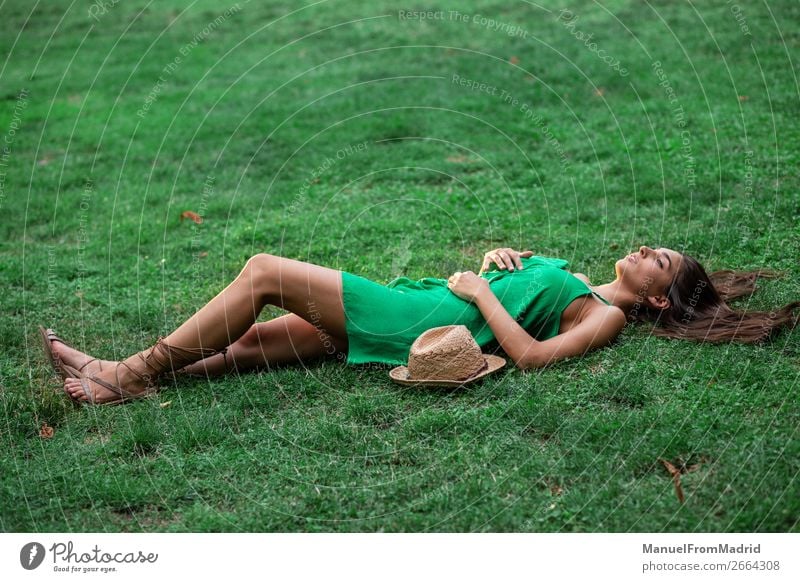 young cheerful woman lying down on the grass Lifestyle Happy Beautiful Leisure and hobbies Summer Human being Woman Adults Nature Grass Park Meadow Smiling