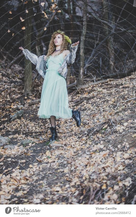 A Young Woman playing with leaves in the woods Lifestyle Elegant Style Design Exotic Joy Beautiful Harmonious Well-being Human being Feminine Young woman