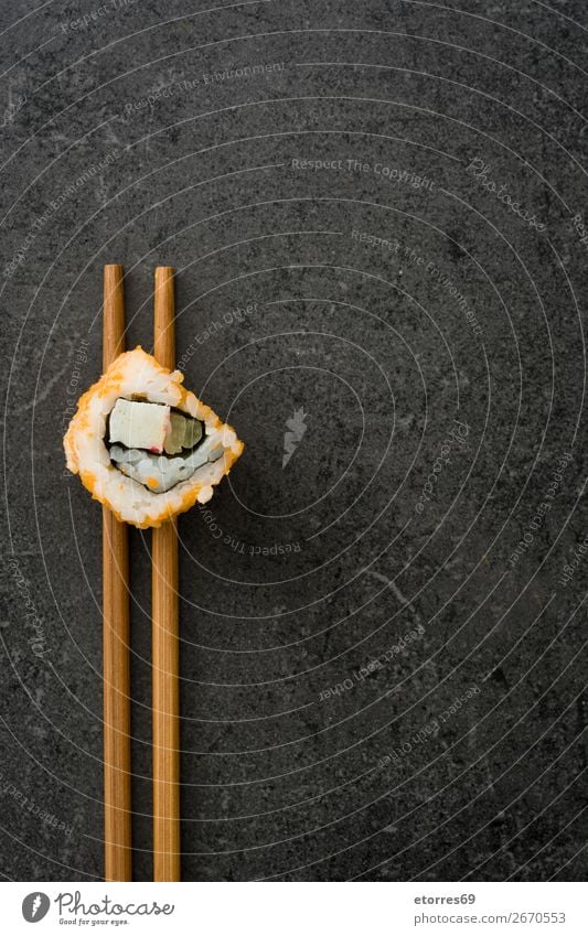 Chopstick with a sushi on black stone. Sushi Food Healthy Eating Food photograph Japanese Rice Fish Salmon Seafood Roll Meal Make Gourmet Asia Raw Seaweed