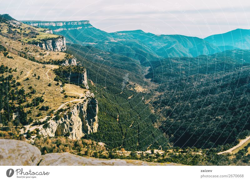 A steep cliff seen from above with a vast expanse of fields full of trees below Beautiful Calm Vacation & Travel Adventure Mountain Hiking Wallpaper Environment