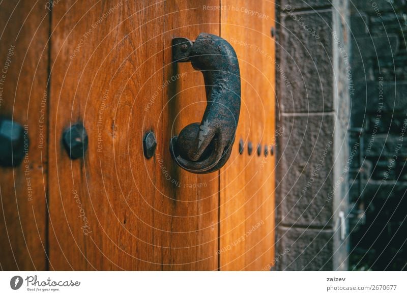 An old metal knocker shaped like a hand on a wooden door of a medieval village Design Vacation & Travel Tourism House (Residential Structure) Decoration Hand