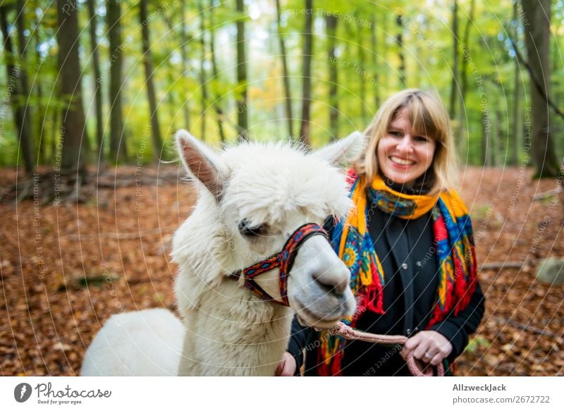 young woman leads white alpaca for a walk in the forest Trip Adventure Feminine Young woman Youth (Young adults) 1 Human being 18 - 30 years Adults Nature