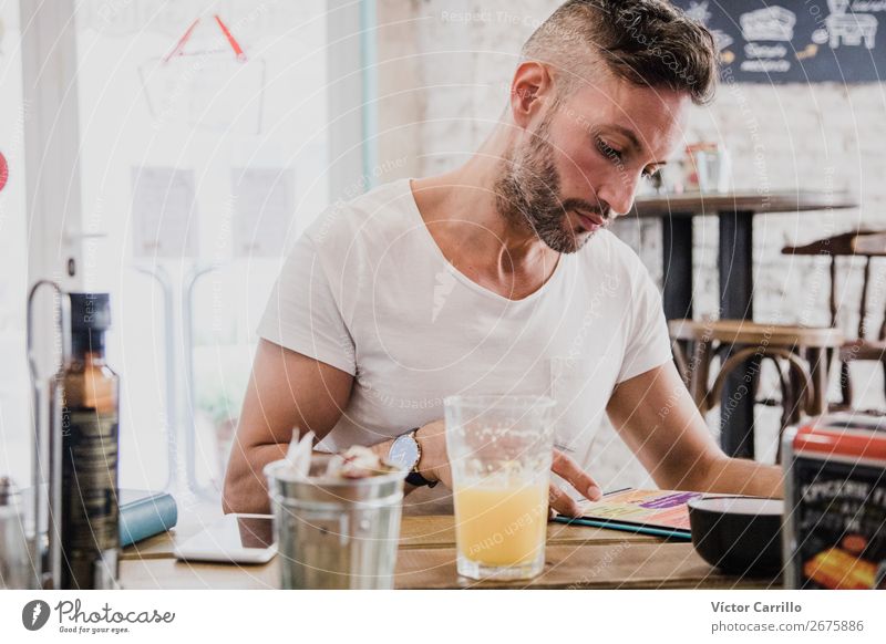 A young Man in an urban cafe Beverage Drinking Juice Human being Masculine Young man Youth (Young adults) Adults 1 18 - 30 years Modern Moody Safety