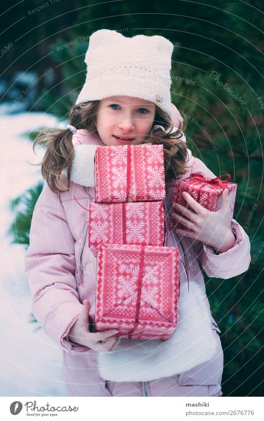 happy kid girl playing outdoor with christmas gifts Lifestyle Joy Happy Playing Vacation & Travel Winter Snow Feasts & Celebrations Christmas & Advent Child