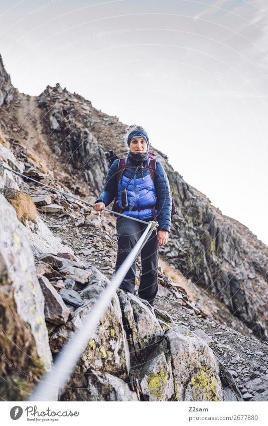 Young woman on via ferrata Adventure Expedition Mountain Hiking Climbing Mountaineering Youth (Young adults) 18 - 30 years Adults Nature Landscape Cloudless sky