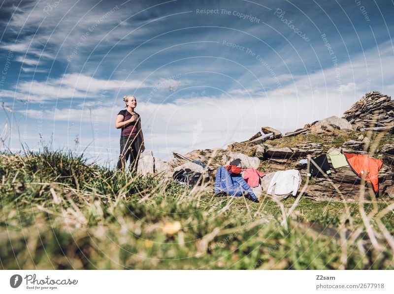 Young woman takes a break at the summit Vacation & Travel Expedition Hiking Climbing Mountaineering Youth (Young adults) Nature Landscape Summer