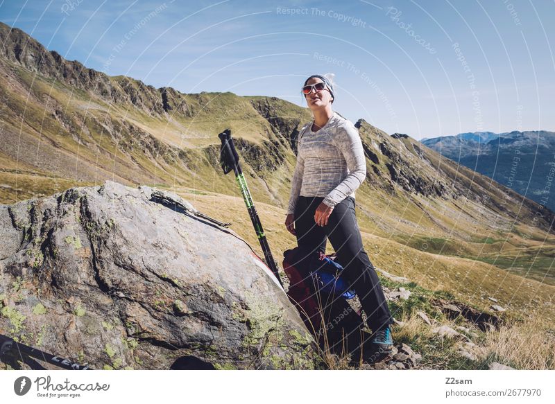 Young woman takes a break while hiking Leisure and hobbies Vacation & Travel Expedition Hiking Climbing Mountaineering Youth (Young adults) Nature Landscape Sun