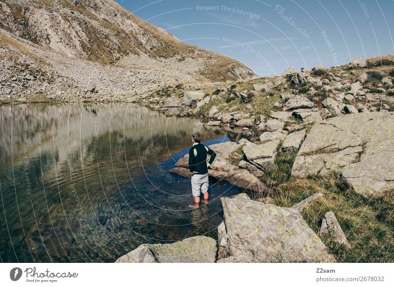 Young man in the water of a mountain lake in South Tyrol Leisure and hobbies Vacation & Travel Expedition Summer Hiking Climbing Mountaineering