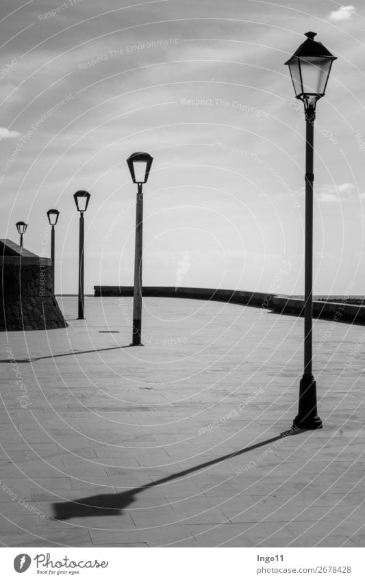 Light and shadow Deserted street lamps Stone Metal Calm Esthetic Eternity Serene Style Black & white photo Exterior shot Shadow