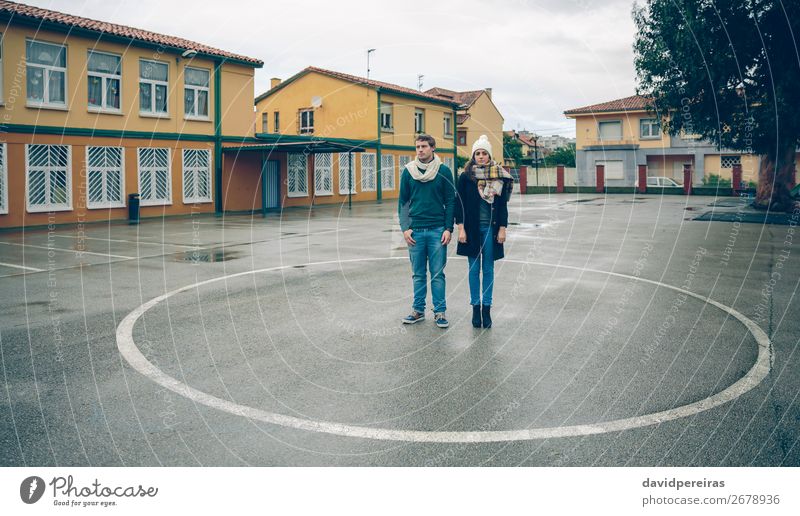 Couple standing inside of circle painted on floor Lifestyle Beautiful Leisure and hobbies Winter Human being Woman Adults Man Friendship Autumn Rain Street