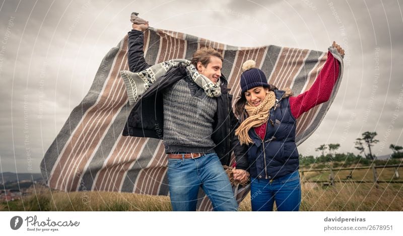 Young couple playing outdoors with blanket in a windy day Lifestyle Joy Happy Beautiful Playing Freedom Winter Mountain Woman Adults Man Couple Nature Sky