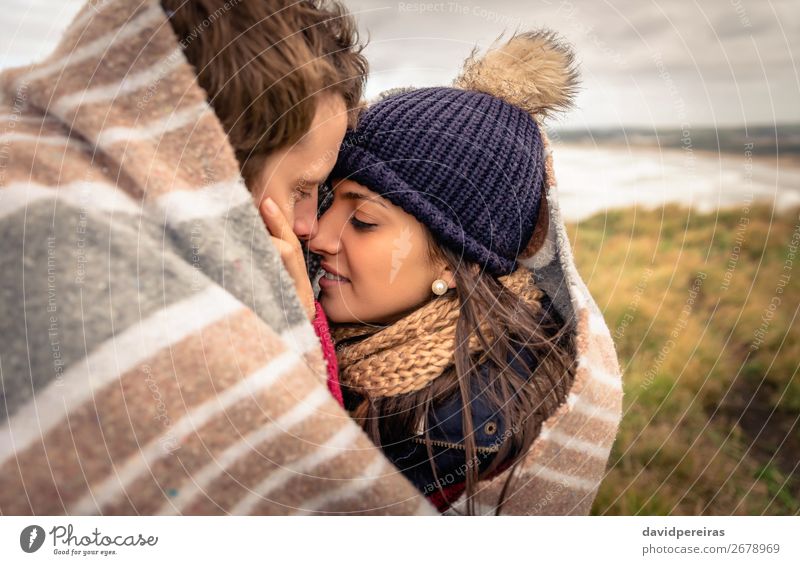 Young couple embracing outdoors under blanket in a cold day Lifestyle Happy Beautiful Ocean Winter Mountain Woman Adults Man Couple Nature Sky Clouds Autumn