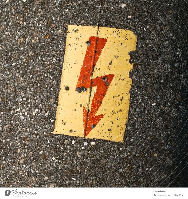 Highly exciting detail. Stone Concrete Sign Signage Warning sign Aggression Threat Sharp-edged Brown Yellow Gray Red Fear Anger Grouchy Force Hatred Movement