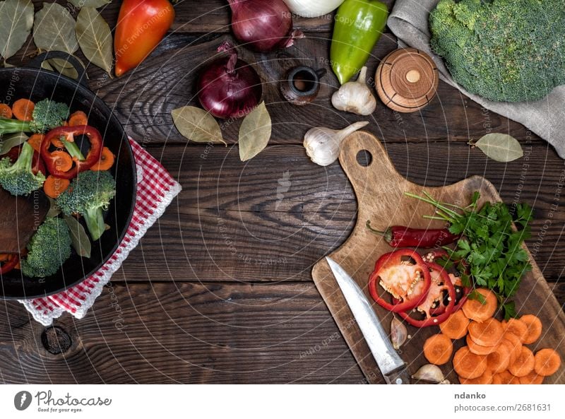 fresh pieces of carrots, broccoli and red pepper Vegetable Herbs and spices Nutrition Eating Vegetarian diet Diet Pan Fork Table Kitchen Nature Plant Wood Fresh