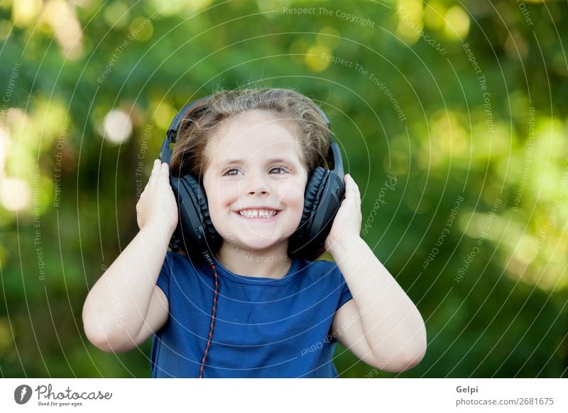 Little girl with headphones outside Lifestyle Joy Happy Beautiful Leisure and hobbies Playing Summer Music Child Technology Human being Woman Adults Infancy