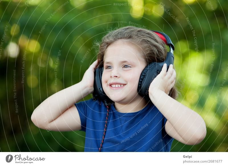 Little girl with headphones outside Lifestyle Joy Happy Beautiful Leisure and hobbies Playing Summer Music Child Technology Human being Woman Adults Infancy